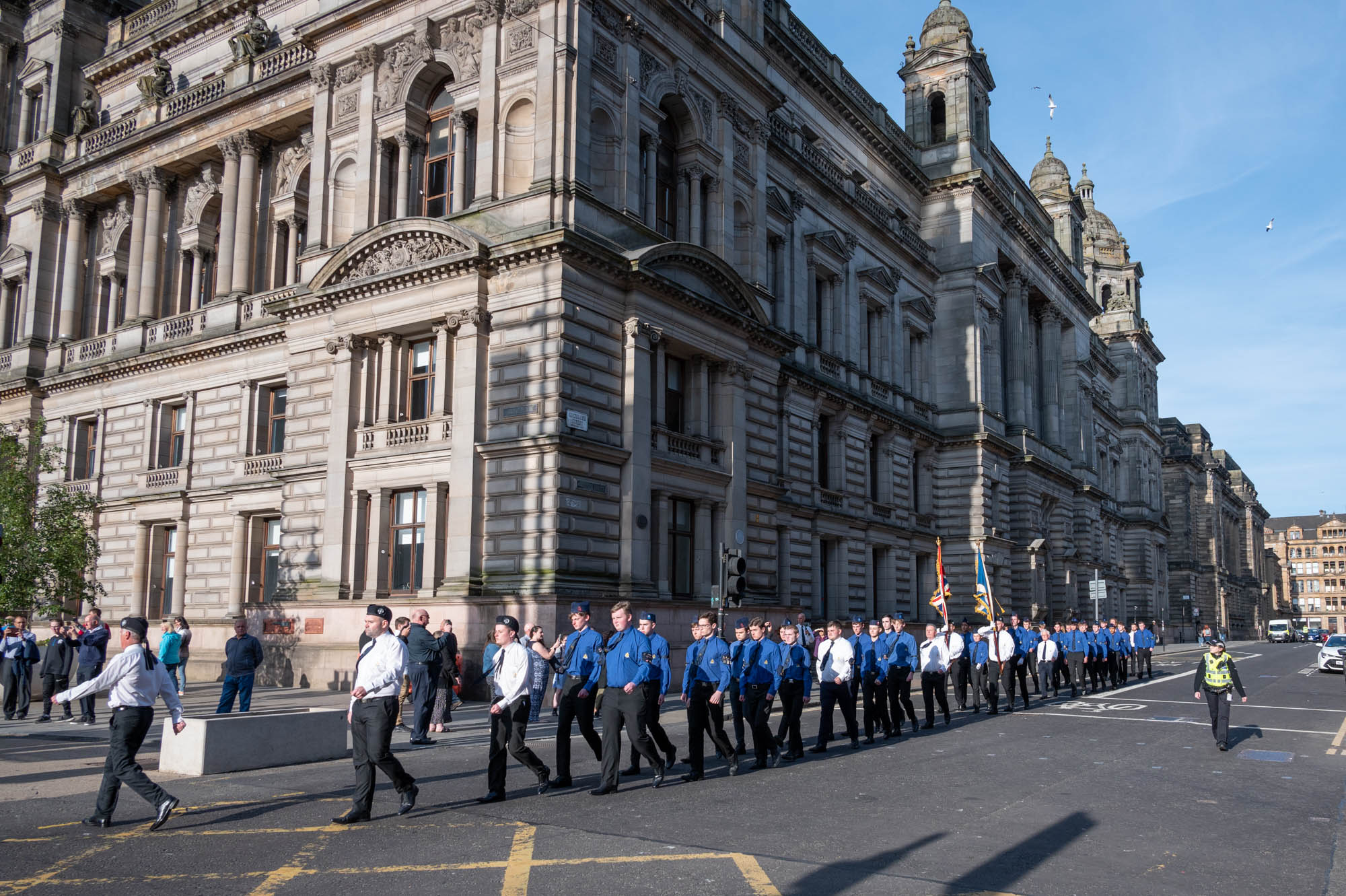 The parade of Queen's Men marching along Cochrane Street at the side of Glasgow City Chambers